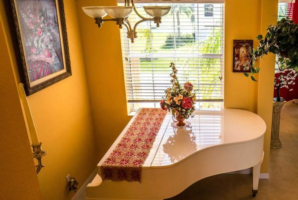 white grand piano in small room